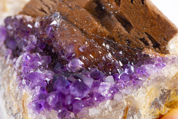 Crystal Stone macro mineral, purple rough amethyst quartz crystals on white background