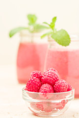 Raspberry smoothie close up photography with fresh summer blended cocktail and ripe berries.