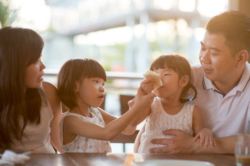 Asian family eating at cafe
