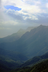 Fototapeta premium valley between the mountains. tops of the mountains. clouds. sunlight through the clouds
