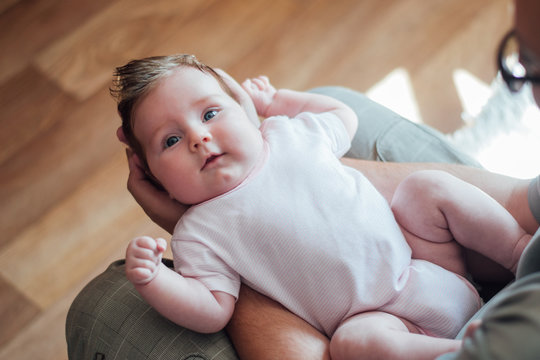 Father Holding Baby On His Lap