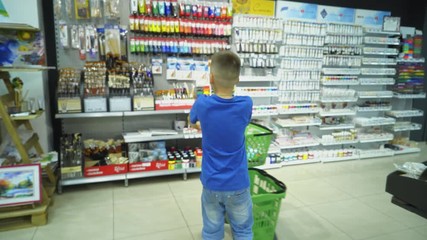 Back to School. Boy choosing school stationery at the supermarket.