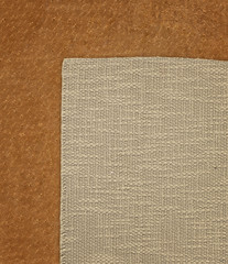 Fototapeta premium Fabric linen textile on the leather background