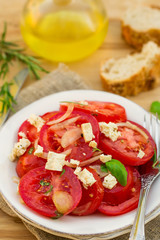 Summer salad with fresh tomatoes, onions and feta cheese