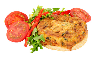 Crustless spinach and kale quiche with fresh salad isolated on a white background