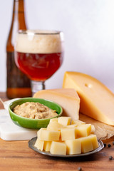 Dutch finger food usually served with glass of beer, cubes hard old cows and goat cheese with Dijon mustard