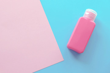 One Pink Bottle On The Pastel Background Light Pink and Blue Colors Mimimal Style Top View Flat Lay
