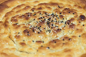 Fresh tandoor cakes baked with seeds. Macro, selective focus. Eastern cuisine.