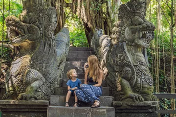 Fototapeten Bali Mom and son travelers discovering Ubud forest in Monkey forest, Bali Indonesia. Traveling with children concept  © galitskaya