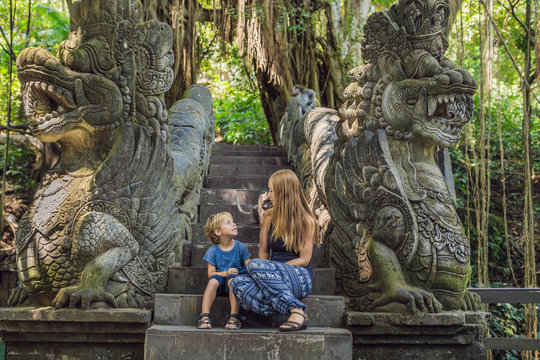 Mom and son travelers discovering Ubud forest in Monkey forest, Bali Indonesia. Traveling with children concept