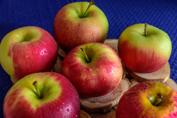 Fresh colorful apples on blue background. Useful for grocery store advertising.