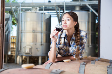 woman is tasting wine at Italian wine factory