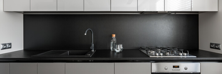 Kitchen with black worktop