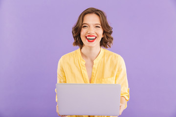 Happy woman isolated over using laptop computer.