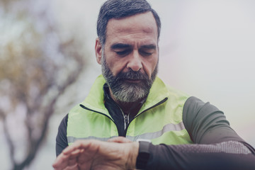 A Man Runner Looking at Watch