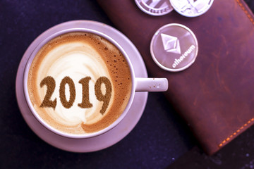 a cup of coffee with a symbol of the NEW YEAR 2019