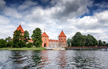 Naklejka na ściany i meble Medieval gothic Trakai Island Castle with stone walls and towers with red tiled roofs in Lake Galve, Lithuania