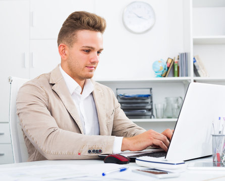 Man working with documents and laptop
