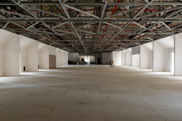 House attic under construction. Interior of  large unfinished mansard.