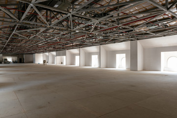 House attic under construction. Interior of  large unfinished mansard.