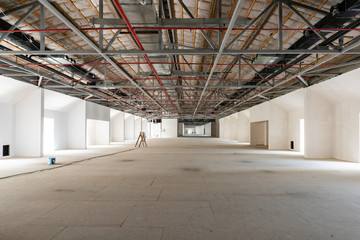 House attic under construction. Interior of  large unfinished mansard.