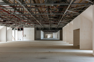 House attic under construction. Interior of  large unfinished mansard.