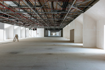 House attic under construction. Interior of  large unfinished mansard.