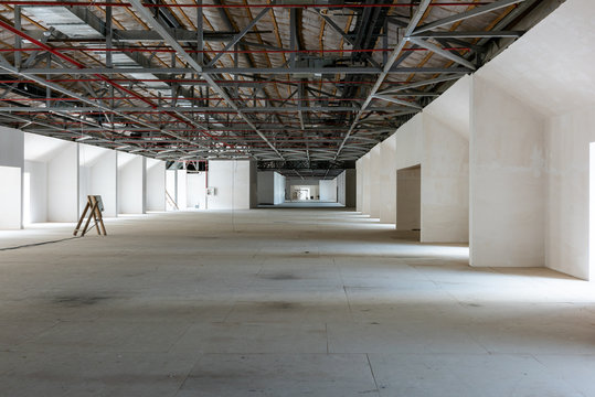 House attic under construction. Interior of  large unfinished mansard.