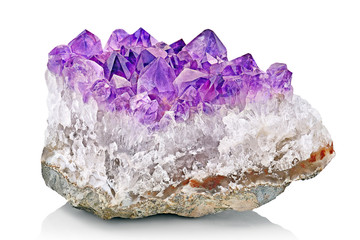 Violet Crystal Stone macro mineral. Purple rough Amethyst quartz crystals geode on white...