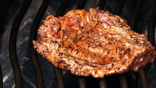 Dolly shot of the juicy Mexican style marinated beef steak on the grill
