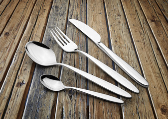Silverware Set with Fork, Knife, and Spoons on textured wooden table