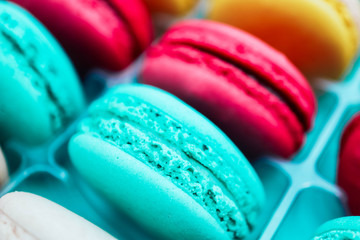 Assorted macaroons sweets, close up, backdrop. Marine, pink and violet.