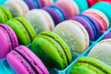 Assorted macaroons sweets, close up, backdrop. Marine, pink and violet.