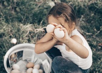 Little girl holding and picking good eggs quality organic and bring to the eye on the farm. Healthy...