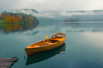 Lonely boat on the water surface of Bled lake, Slovenia