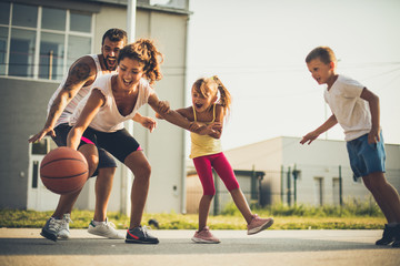 Happy family playing basketball. Spring season. - 219948491