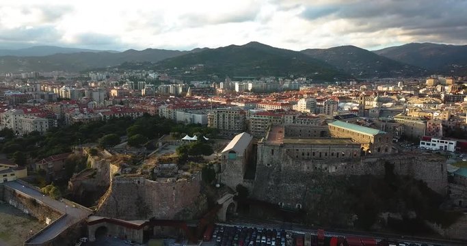 Fortress of Priamar in Savona Italy in a beautiful sunset and build and houses in background by drone