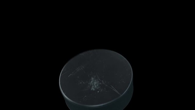 Set of 4 Videos. Beautiful Hockey Puck Hits the Camera in Slow Motion on Black Background. Hockey 3d Animation of Flying Puck Isolated. Sport Concept. 4k Ultra HD 3840x2160.