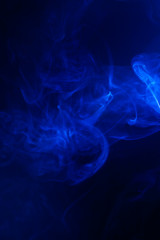 Blue smoke on black background.