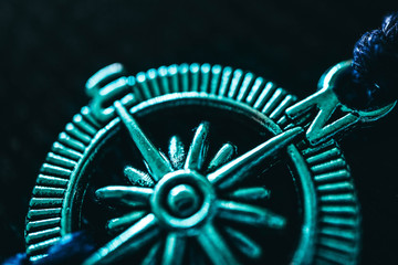 Jewelry compass, macro view. Traveling, adventure, way finding concept.