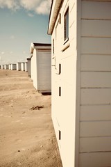 White bath houses at beach.