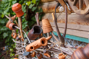 Old clay ware on a wicker rustic fence