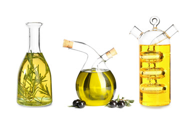 Different bottles with olive oil on white background