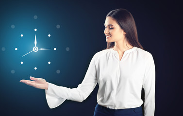 Young businesswoman holding something on black background