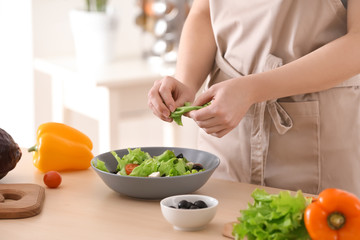Obraz na płótnie Canvas Woman preparing tasty salad at table. Diet food