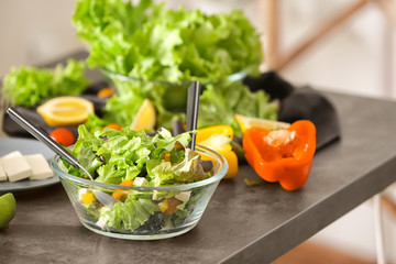 Bowl with fresh salad on table. Diet food
