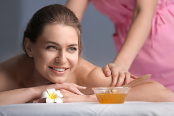 Obraz na płótnie Canvas Young woman having back massage in beauty salon