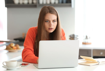 Female freelancer working on laptop at home