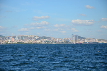 Fototapeta premium View to Istanbul from Prince's Islands (Büyükada). Sea cityscape with modern skyscrapers of Istanbul. Beautiful blue sky with white clouds