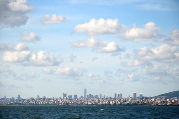 Obraz premium View to Istanbul from Prince's Islands (Büyükada). Sea cityscape with modern skyscrapers of Istanbul. Beautiful blue sky with white clouds
